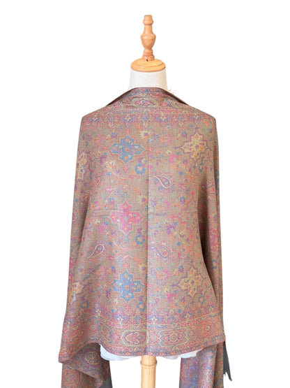 Noori Couture pashmina shawl in sea weed grey with intricate paisley patterns in coral, gold, and violet on a mannequin.