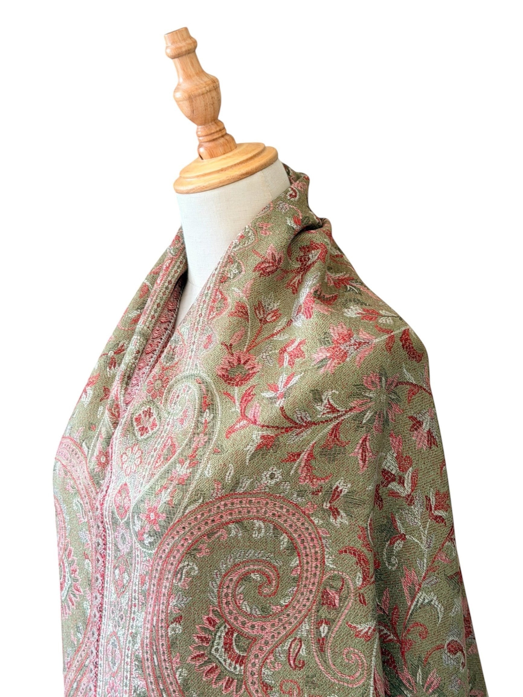 Noori Couture pashmina shawl in sage green with rose and earth-toned woven paisley patterns and delicate fringe edges.