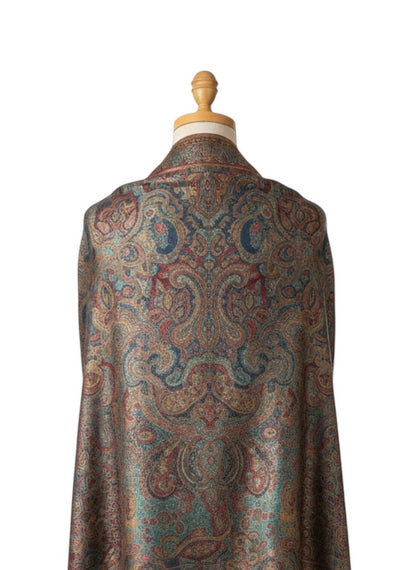 Noori Couture paisley patterned woven scarf in peacock shades with fringed edges.
