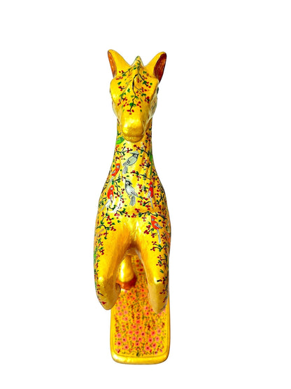 Noori Couture hand-painted paper mâché horse sculpture, gold with floral and bird motifs, on a decorative base.