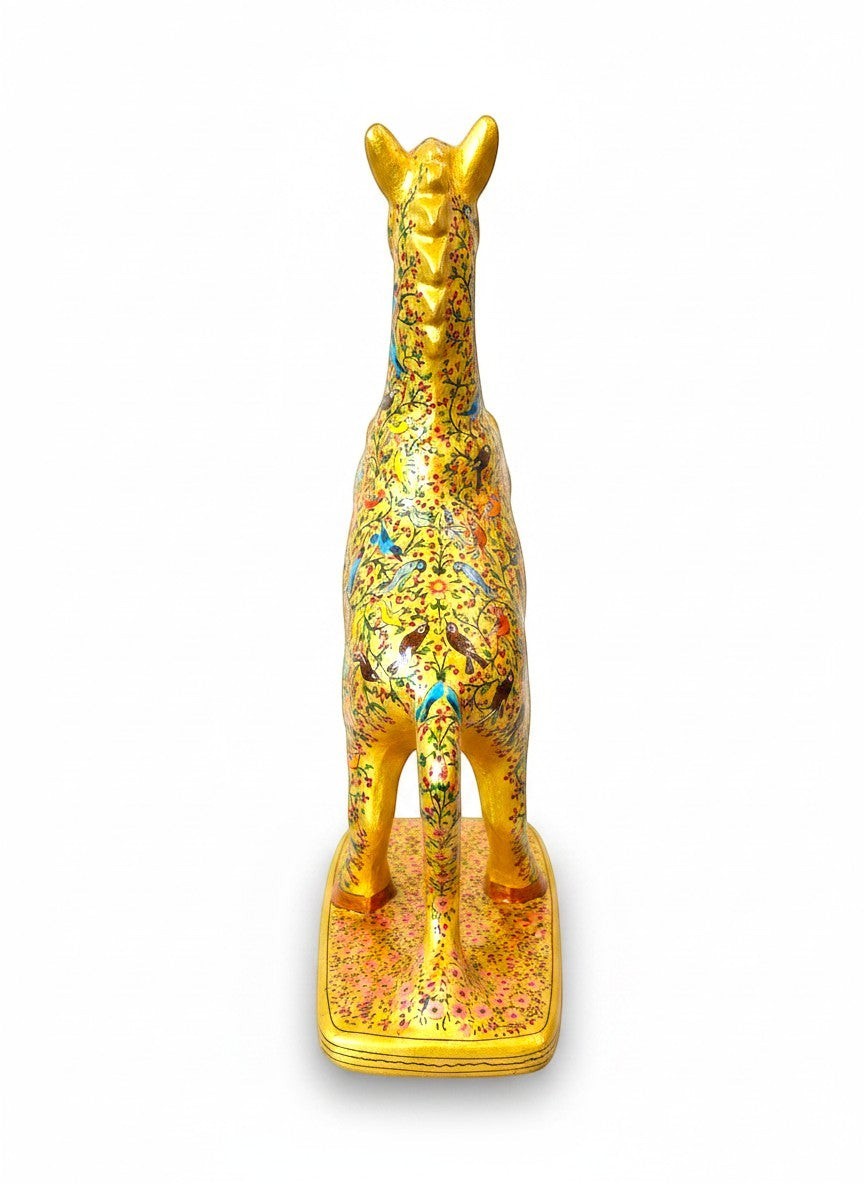 Noori Couture hand-painted paper mâché horse sculpture, gold with intricate floral and bird motifs, on a decorative base.