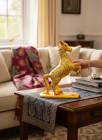 Noori Couture hand-painted paper mâché horse sculpture, yellow with intricate bird and floral details on a gold base.