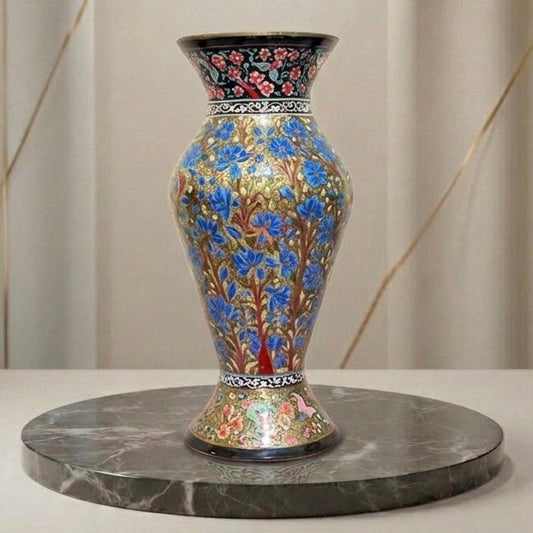 Noori Couture hand-painted paper mâché vase with blue floral motifs on an earthy gold base. Limited edition art piece.