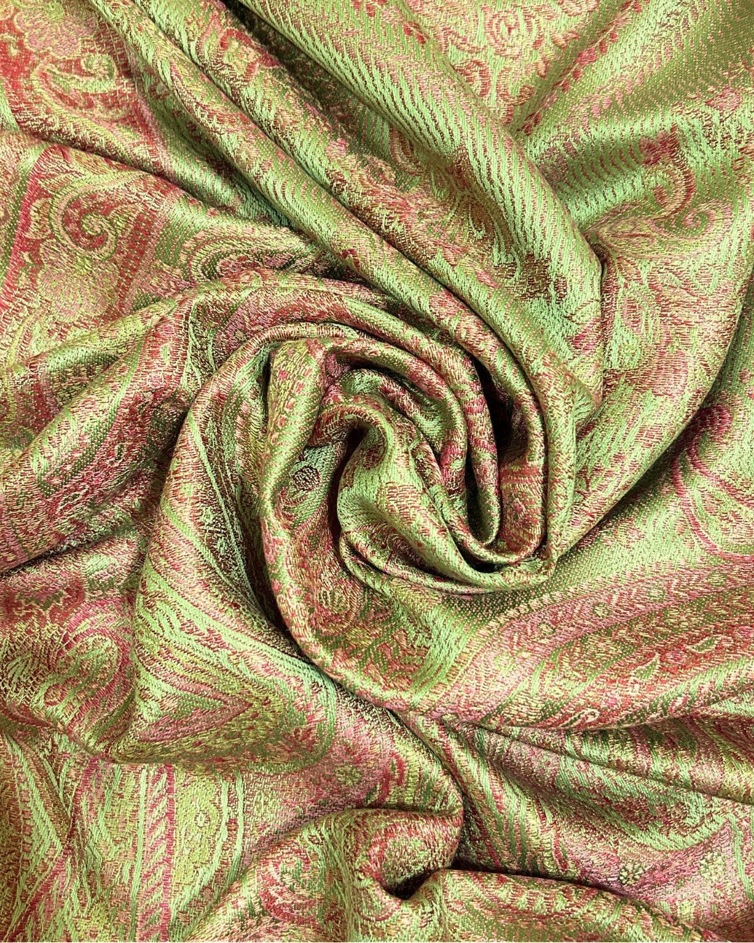 Noori Couture handwoven pure silk shawl in peridot green with intricate paisley pattern in pink and gold tones.