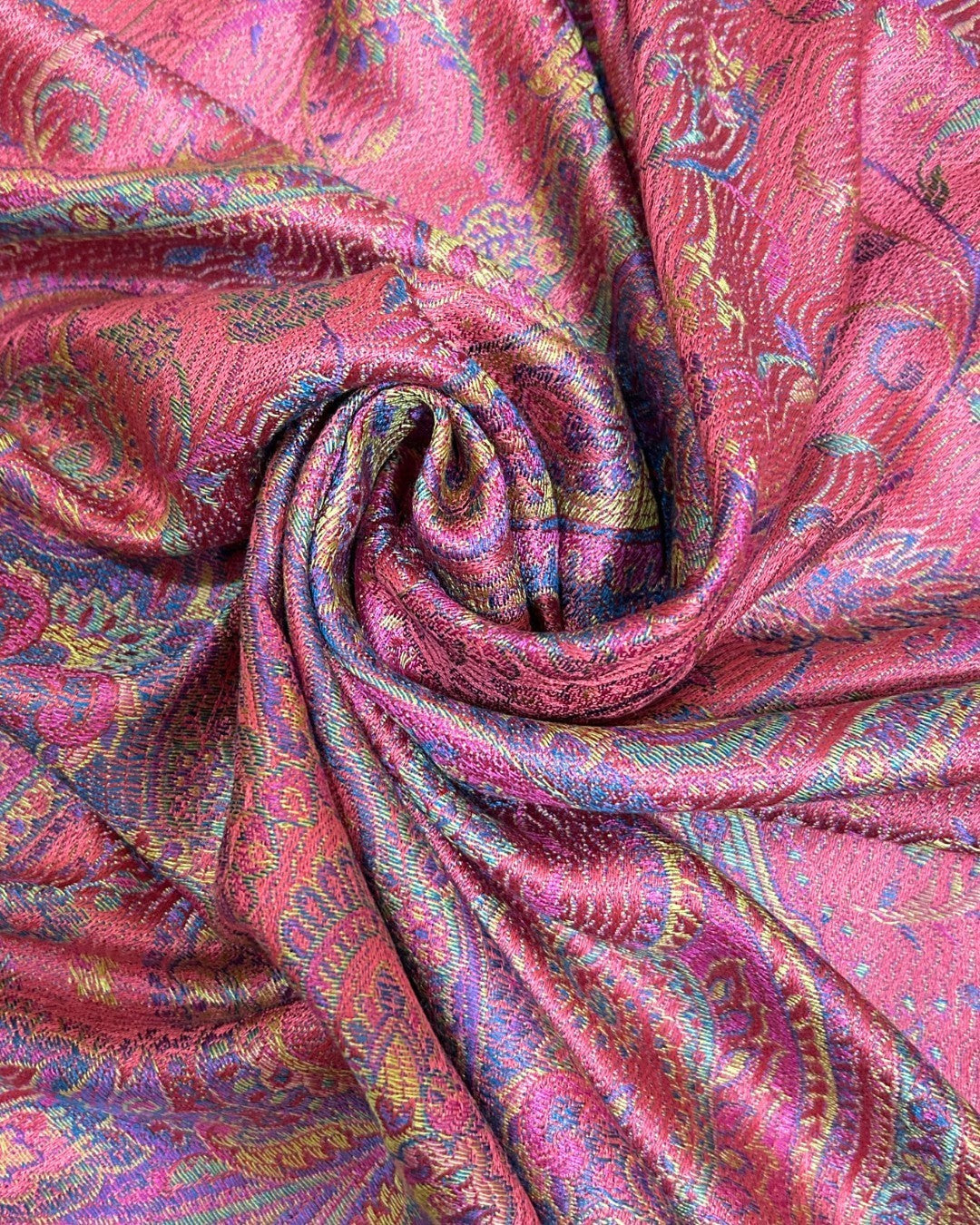 Noori Couture pink mulberry silk shawl with intricate paisley pattern in purple, gold, and blue. Features delicate fringe detailing.