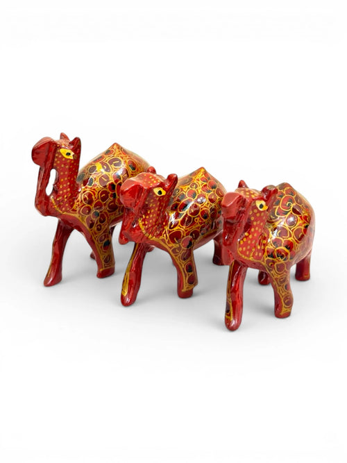 Noori Couture set of 3 brown papier-mâché camel figurines with intricate gold and brown floral hand-painted detailing.