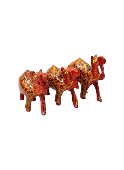 Noori Couture set of 3 red papier-mâché camel figurines with intricate gold and black floral detailing.
