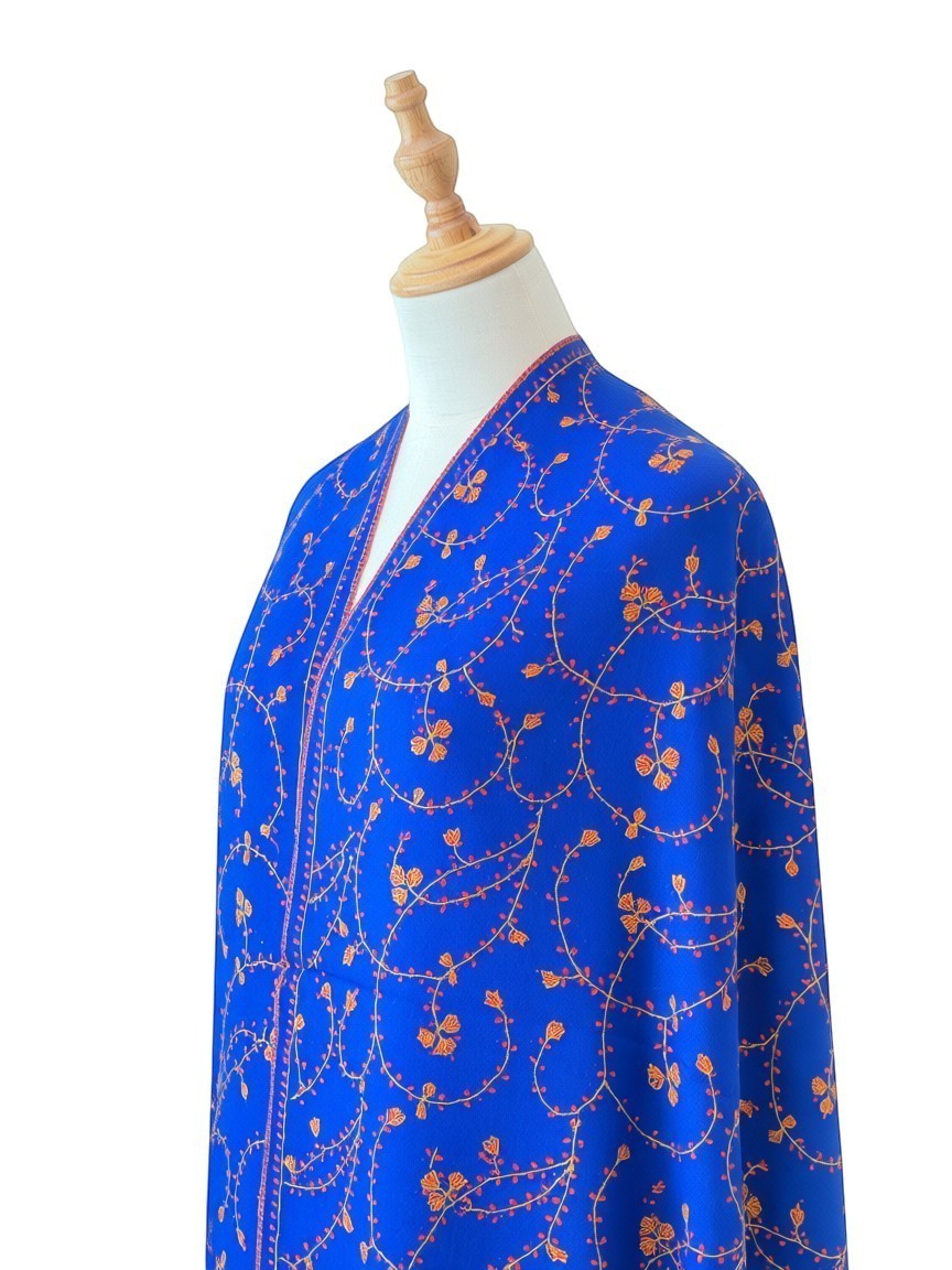 Noori Couture royal blue handwoven shawl with intricate orange floral Sozni Jali embroidery and a contrasting red border.