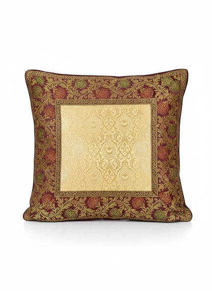 Noori Couture Royal Cushion Cover in gold brocade with intricate zari detailing and floral motifs in burgundy and green.