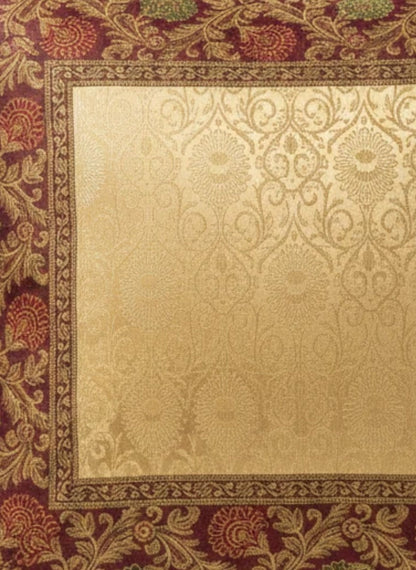 Noori Couture Royal Cushion Cover in gold brocade with intricate zari detailing and floral motifs in red and green.