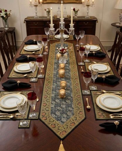 Noori Couture Royal Dining Set: 13-piece table runner, placemats, and coasters in deep blue with gold floral pattern and gold tassels.