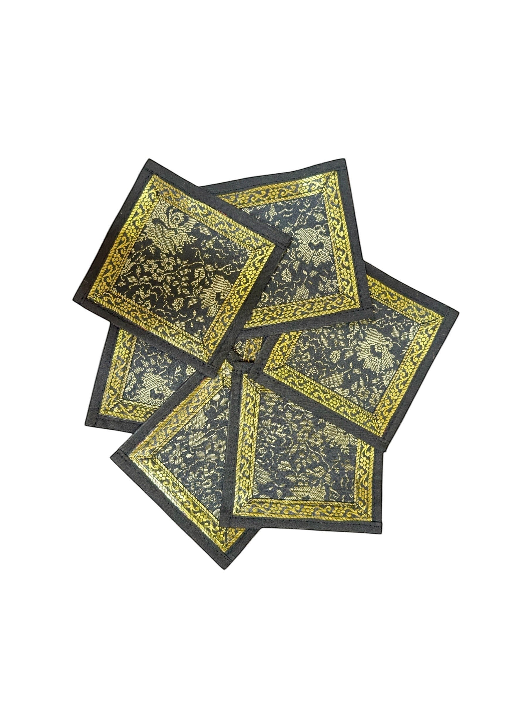 Noori Couture Royal Dining Set coasters with gold floral pattern on black fabric and gold border.