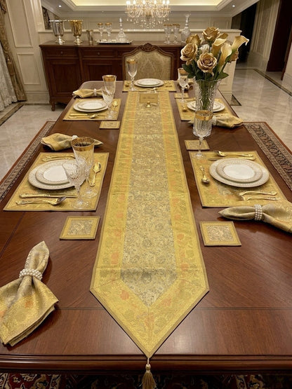 Noori Couture 13-piece Royal Zari dining set with gold paisley Tanchoi weaving, zari borders, and tassels on silk fabric.