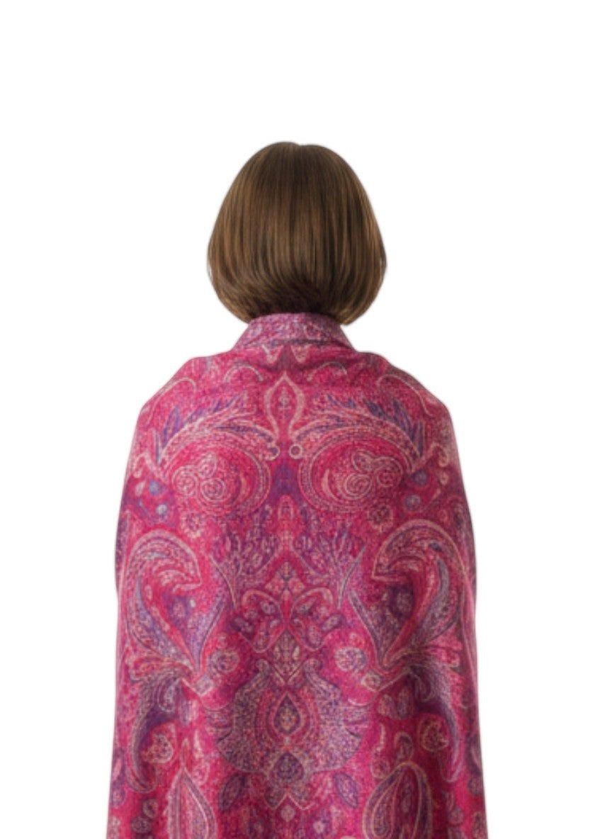 Noori Couture ruby pink pure silk shawl with paisley pattern and fringe detail, worn by a woman.