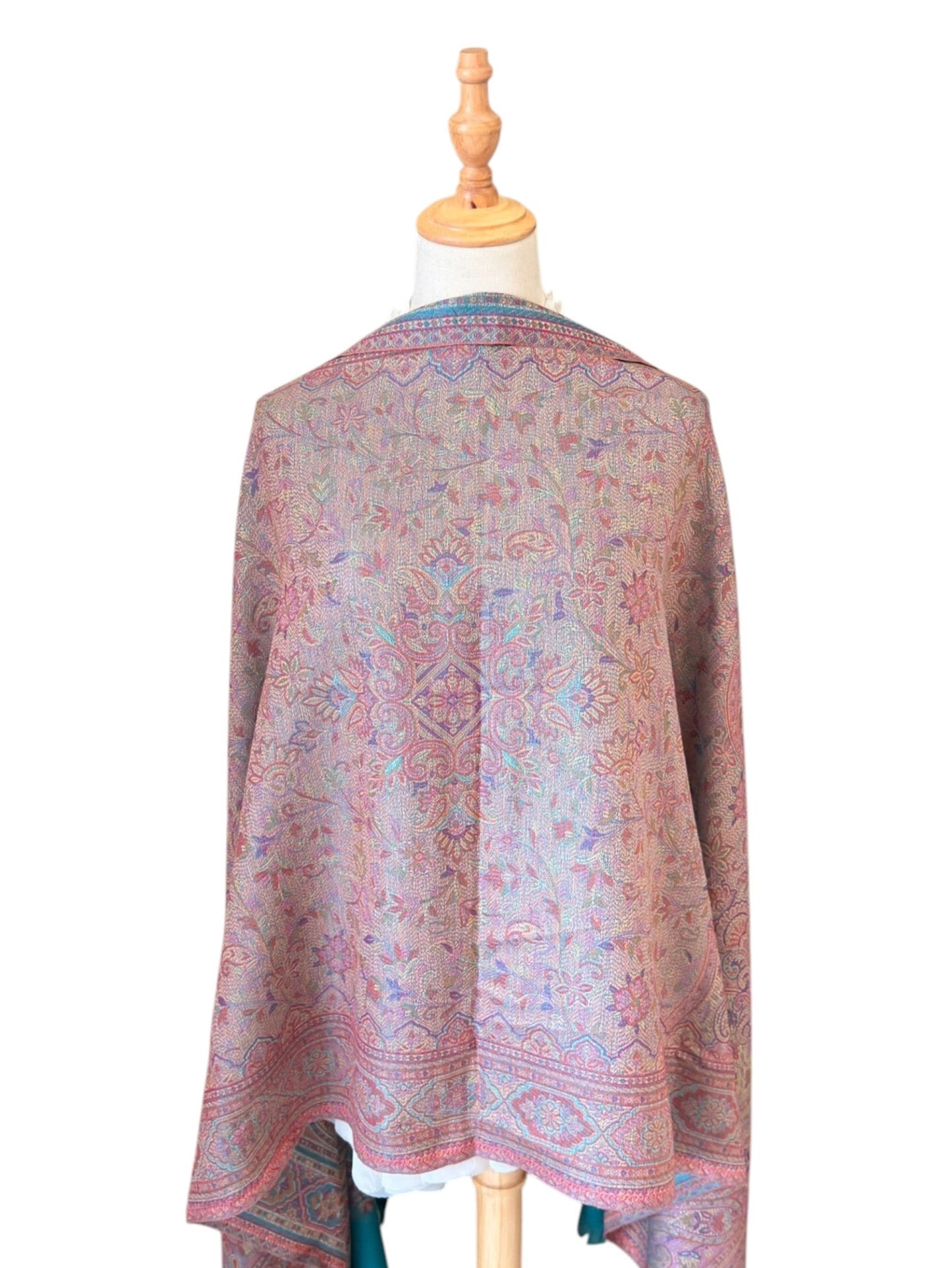 Noori Couture seaweed green pashmina shawl with intricate paisley patterns and delicate fringe on a mannequin
