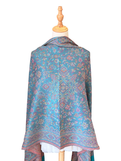 Noori Couture seaweed green pashmina shawl with intricate paisley motifs and delicate fringe on a mannequin