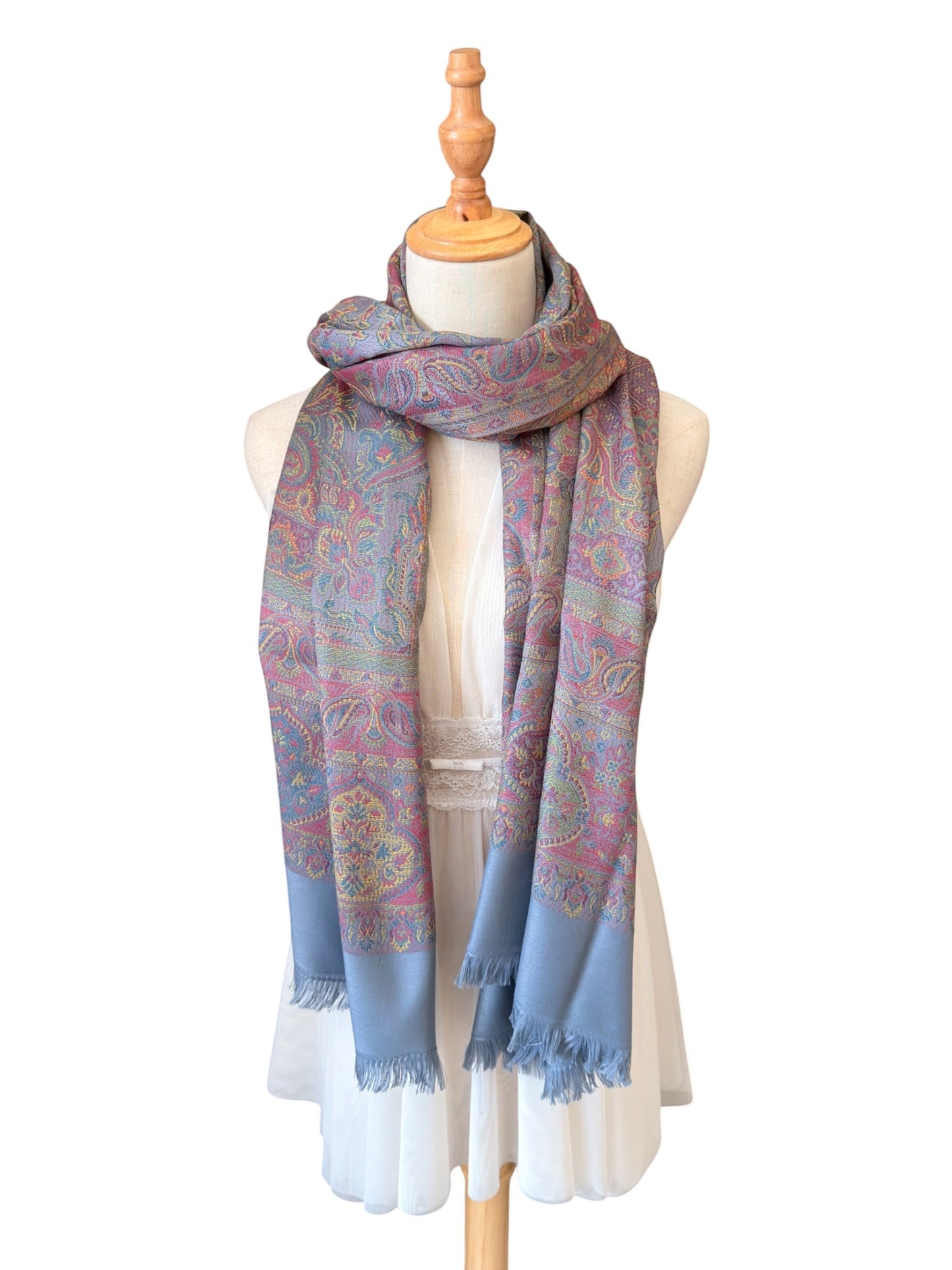 Noori Couture slate grey handwoven pashmina shawl featuring intricate multi-colored paisley patterns and fringed edges.