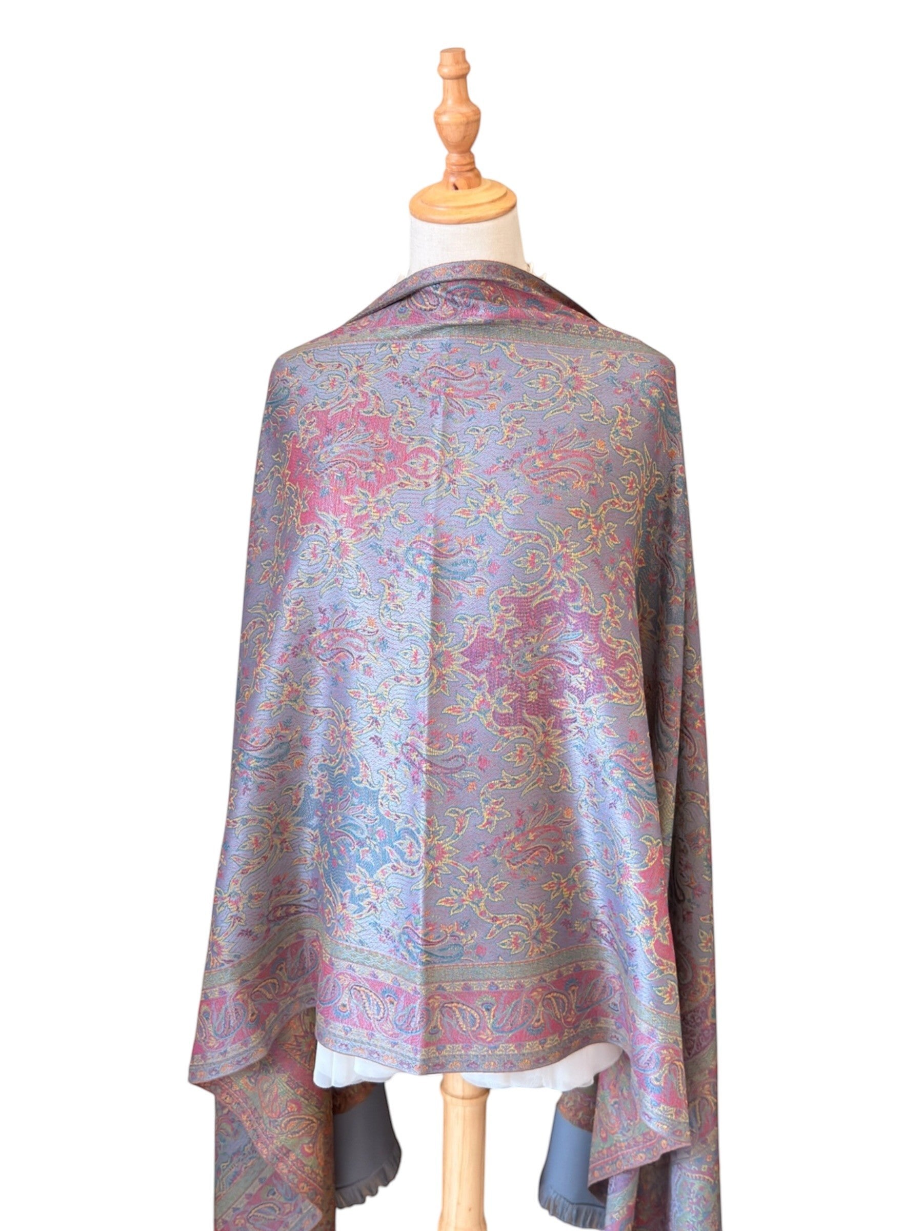 Noori Couture slate grey handwoven pashmina shawl featuring intricate multi-colored paisley patterns and fringe edges.