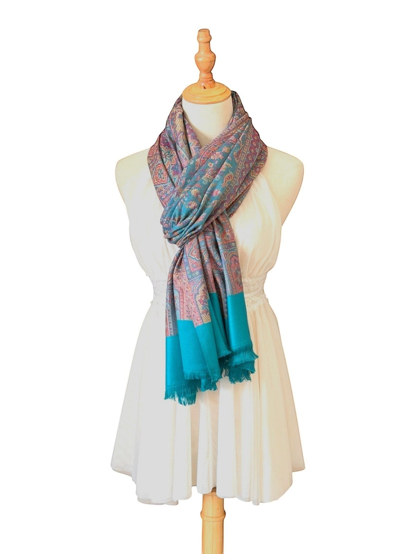 Noori Couture pashmina shawl with intricate teal and violet paisley patterns and fringed hem on a mannequin