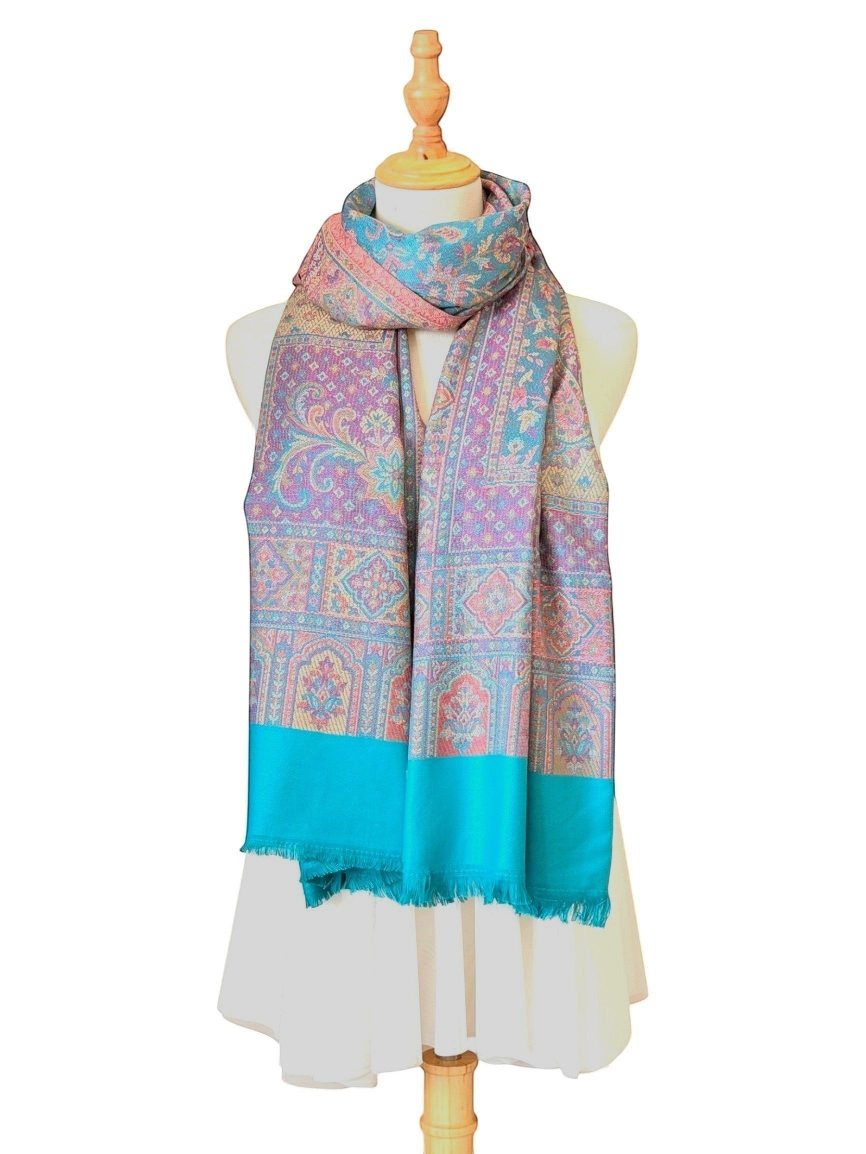 Noori Couture pashmina shawl featuring intricate teal and violet paisley patterns with a delicate fringed hem.