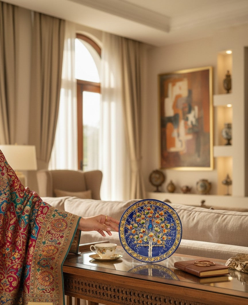 Noori Couture handpainted papier-mâché decorative plate with Tree of Life motif in blue, orange, green, and gold.