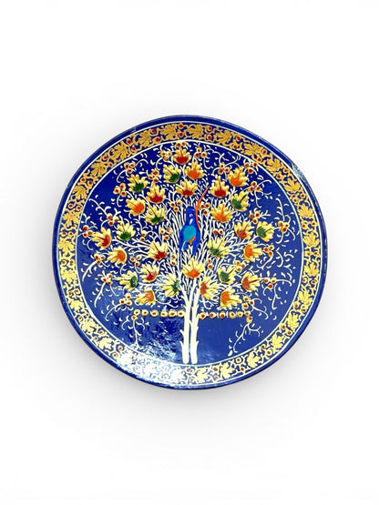 Noori Couture handpainted papier-mâché decorative plate with Tree of Life motif, deep blue with gold accents.