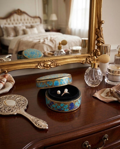 Noori Couture ornate oval papier-mâché keepsake box with turquoise and gold inlay, red velvet interior holding pearl earrings and a ring.
