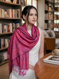 Noori Couture handwoven violet pink mulberry silk shawl with intricate paisley patterns draped over a woman's shoulders