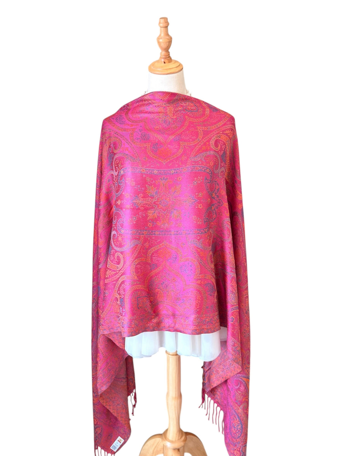 Noori Couture handwoven violet pink mulberry silk shawl with intricate paisley patterns on a dressmaker mannequin.